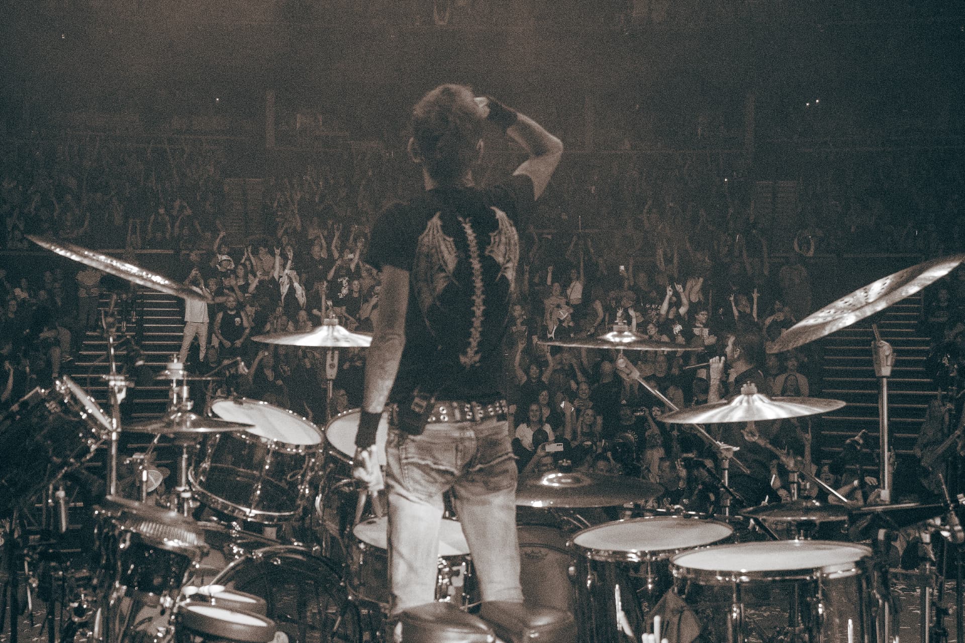 Drummer standing behind the kit facing the packed Yaamava Theater crowd