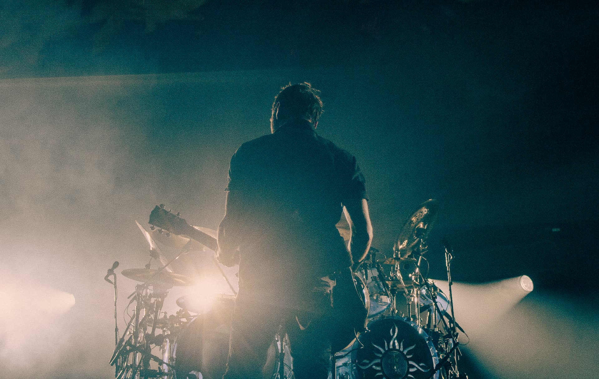 Drummer silhouetted in haze and backlight during Godsmack
